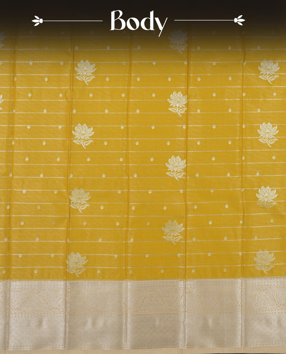 Light olive yellow colour Semi Silk Saree featuring silver zari floral motifs on the body, complemented by a muted brown traditional pallu and border, and paired with a matching blouse piece.