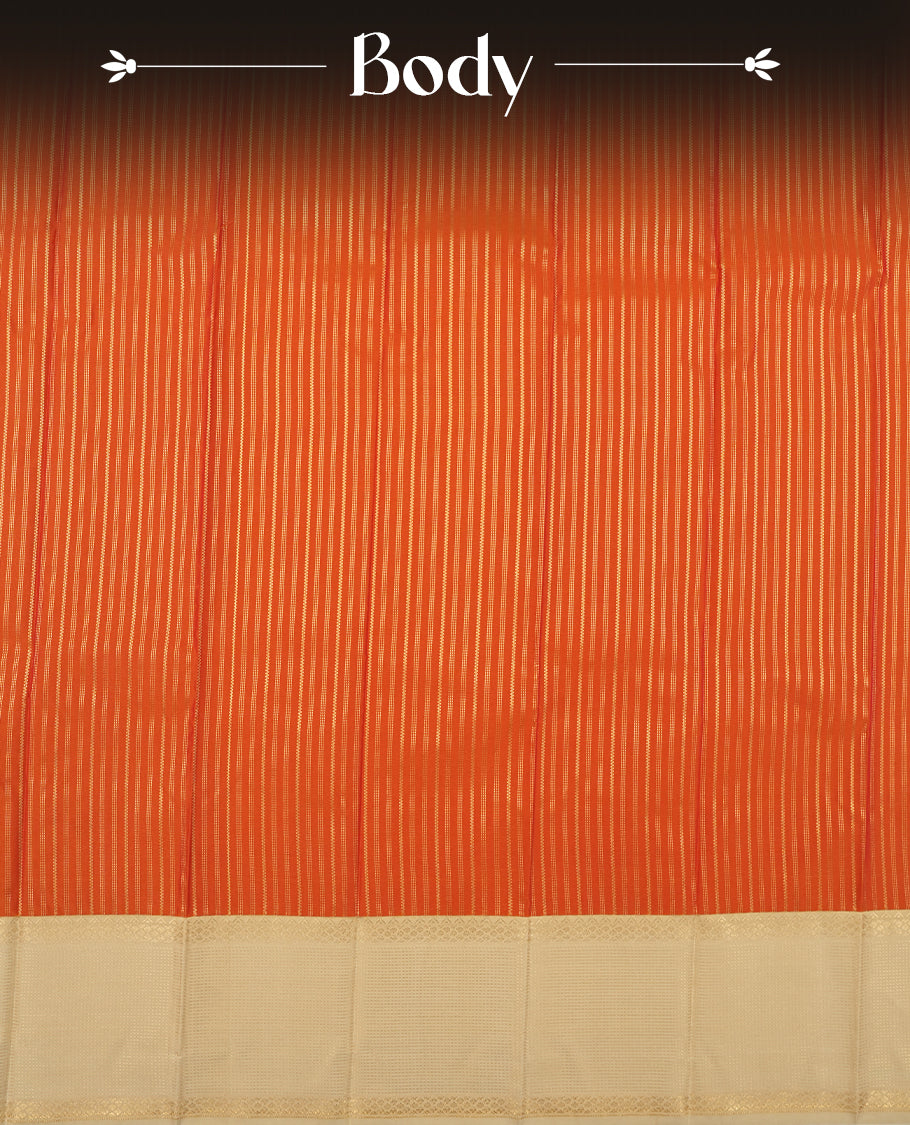 Burnt orange colour Semi Silk Saree with gold zari striped patterns on the body, paired with a contrasting cream colour traditional pallu and border, and a matching blouse piece.