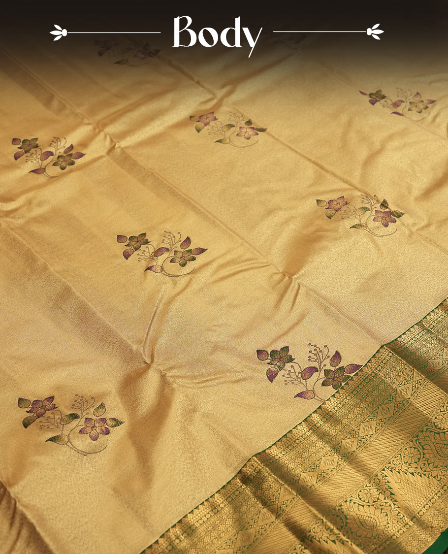 Golden colour Tissue Brocade Saree features intricate a green colour flower Motifs on body and a green colour traditional border & pallu with patterns, paired with matching blouse