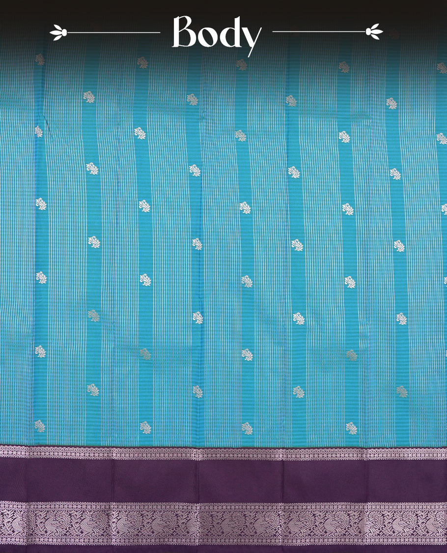 Aqua blue colour Semi Silk Saree with silver zari patterns on the body, paired with a contrasting dark violet colour traditional pallu and border, and a matching blouse piece.