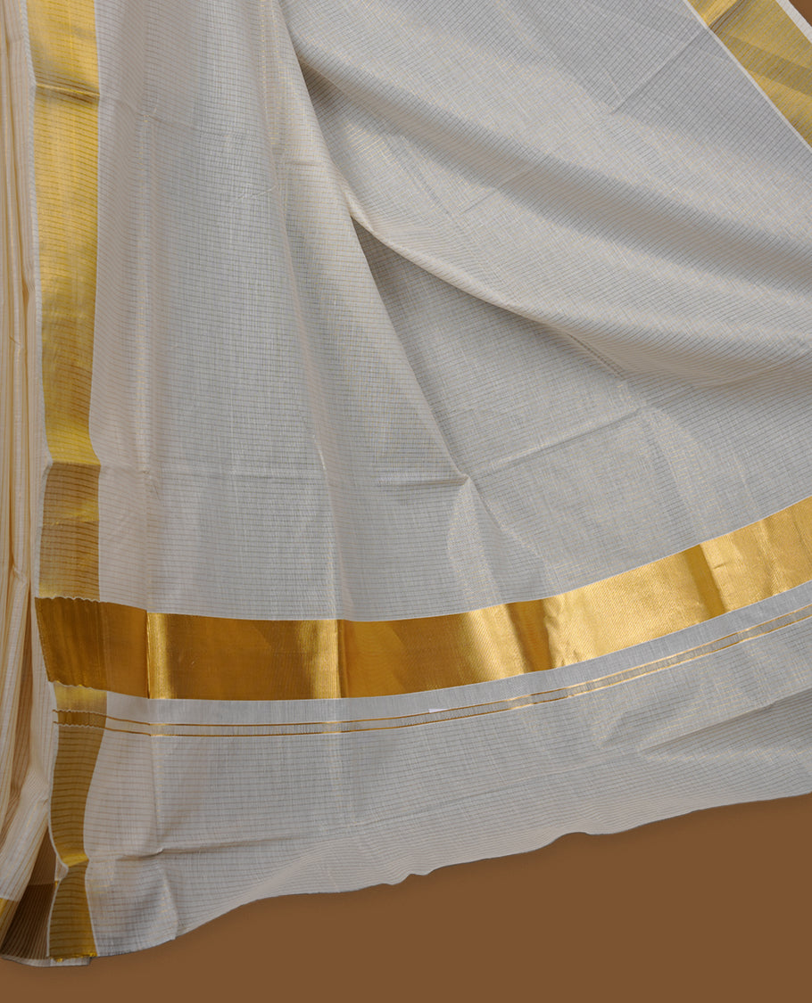 Off-white colour cotton Kerala saree featuring a traditional gold kasavu border with a fine striped texture across the body and pallu, offering a clean, elegant look, and paired with a matching blouse.