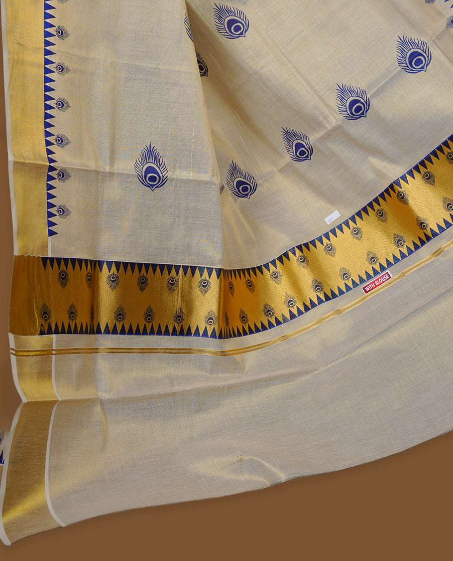 Off-white colour tissue Kerala saree with a classic gold kasavu border, highlighted by royal blue peacock motifs across the body and pallu, and paired with a matching blouse.