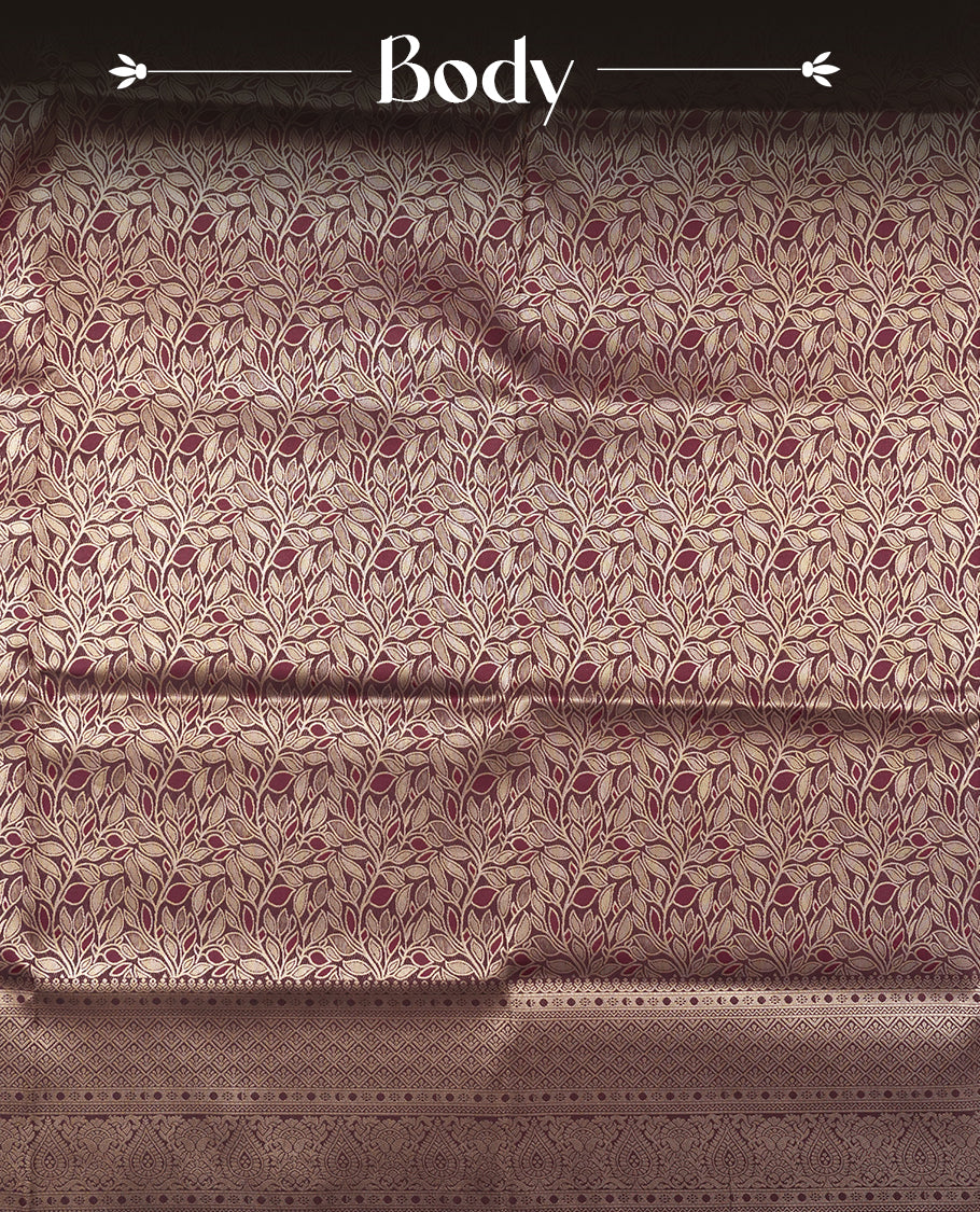 Dark Brown colour semi soft silk saree featuring an all-over woven leaf pattern in gold colour, finished with a matching border adorned with detailed paisley and floral motifs, and a matching blouse piece.