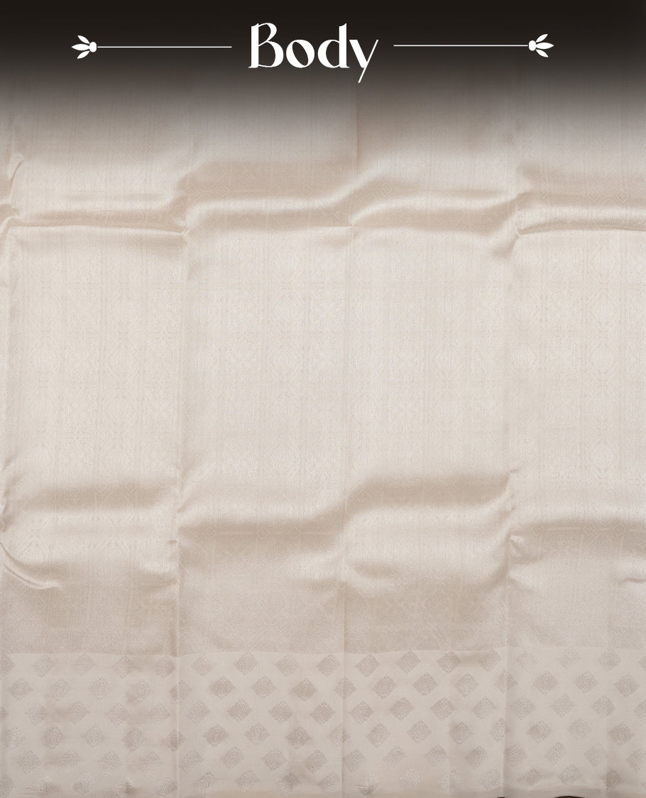 Off white colour semi soft silk saree featuring a self coloured textured patterned body, complemented by self coloured Square motifs on pallu & border and a matching blouse piece.