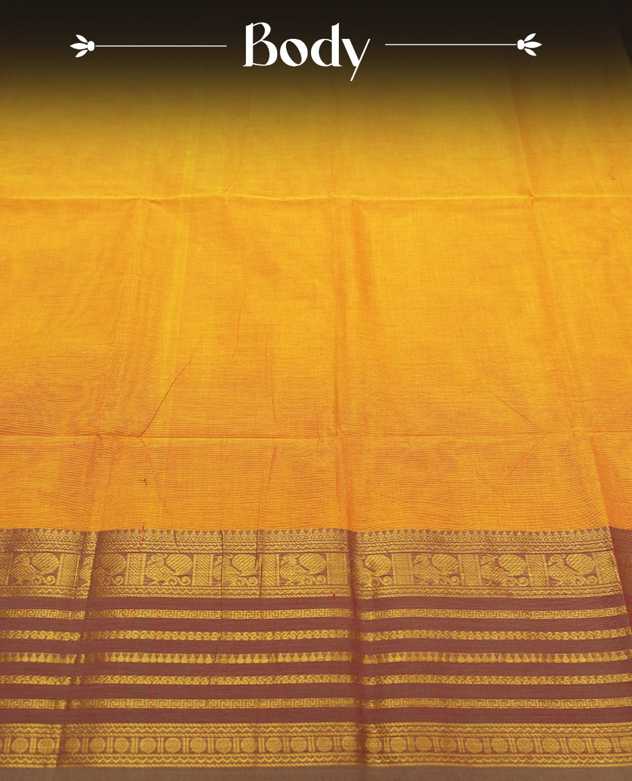 Marigold colour Silk Cotton Saree with Rich Maroon Zari Borders Showcasing Traditional Peacock and Floral Panels, Multiple Horizontal Zari Lines on the Pallu, and a Coordinated Matching Blouse Piece