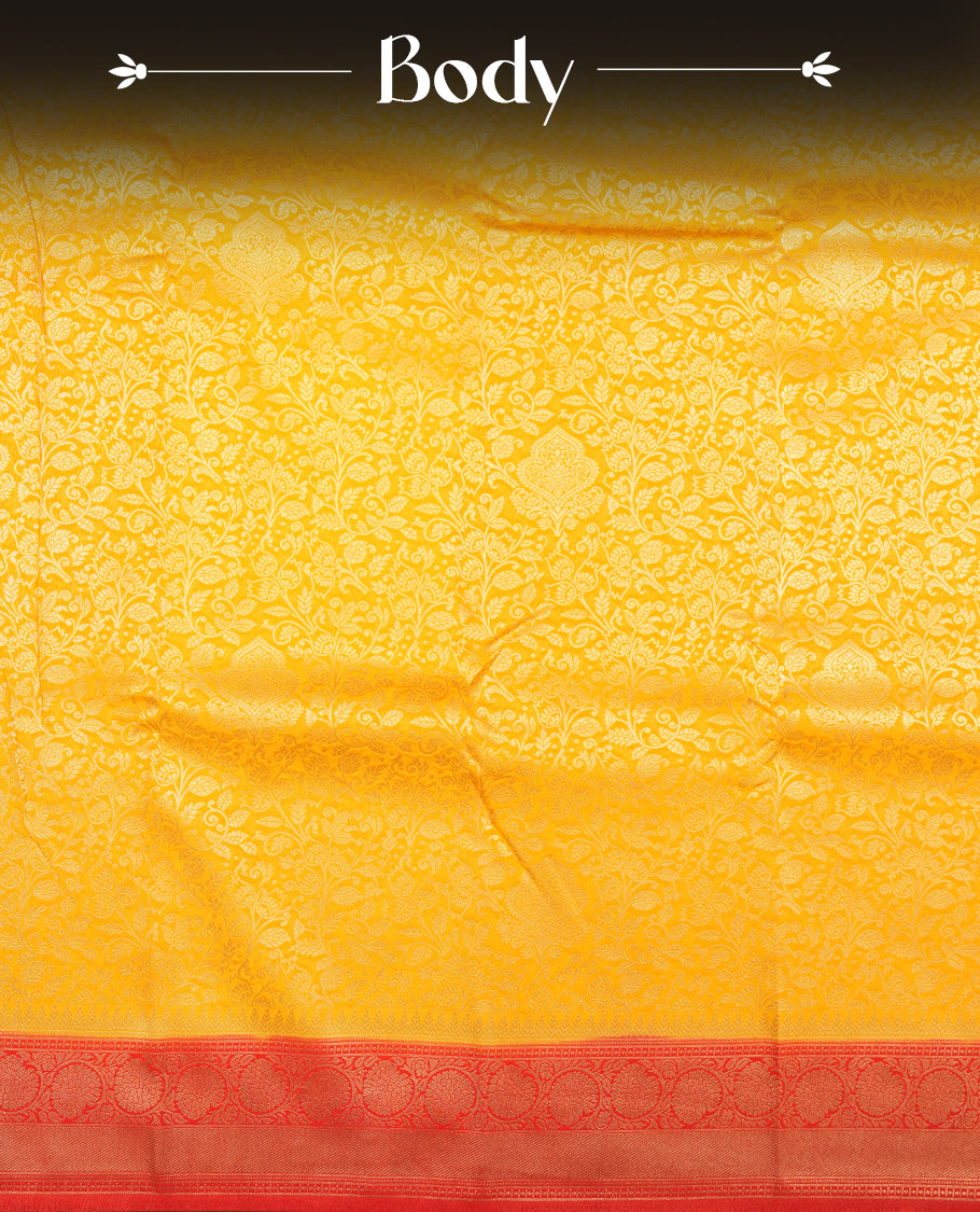 Yellow colour semi silk brocade saree featuring intricate Gold Floral kodi patterns across the body, complemented by a Contrast red colour woven border and pallu, paired with a matching blouse.