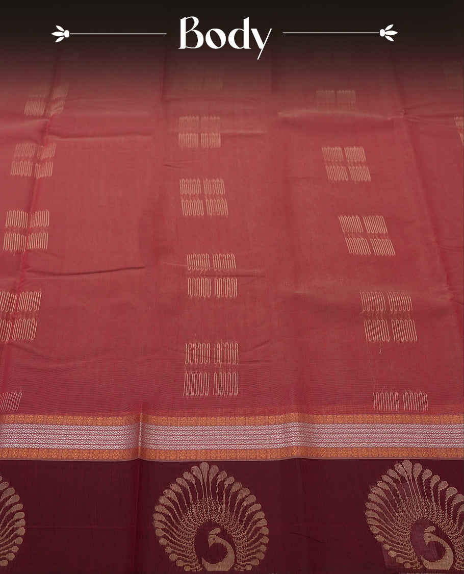 Maroon colour tissue cotton saree featuring elegant silver & copper zari motifs, a delicate zari border, and a beautifully woven pallu & Paired with a matching blouse, perfect for festive and traditional occasions.