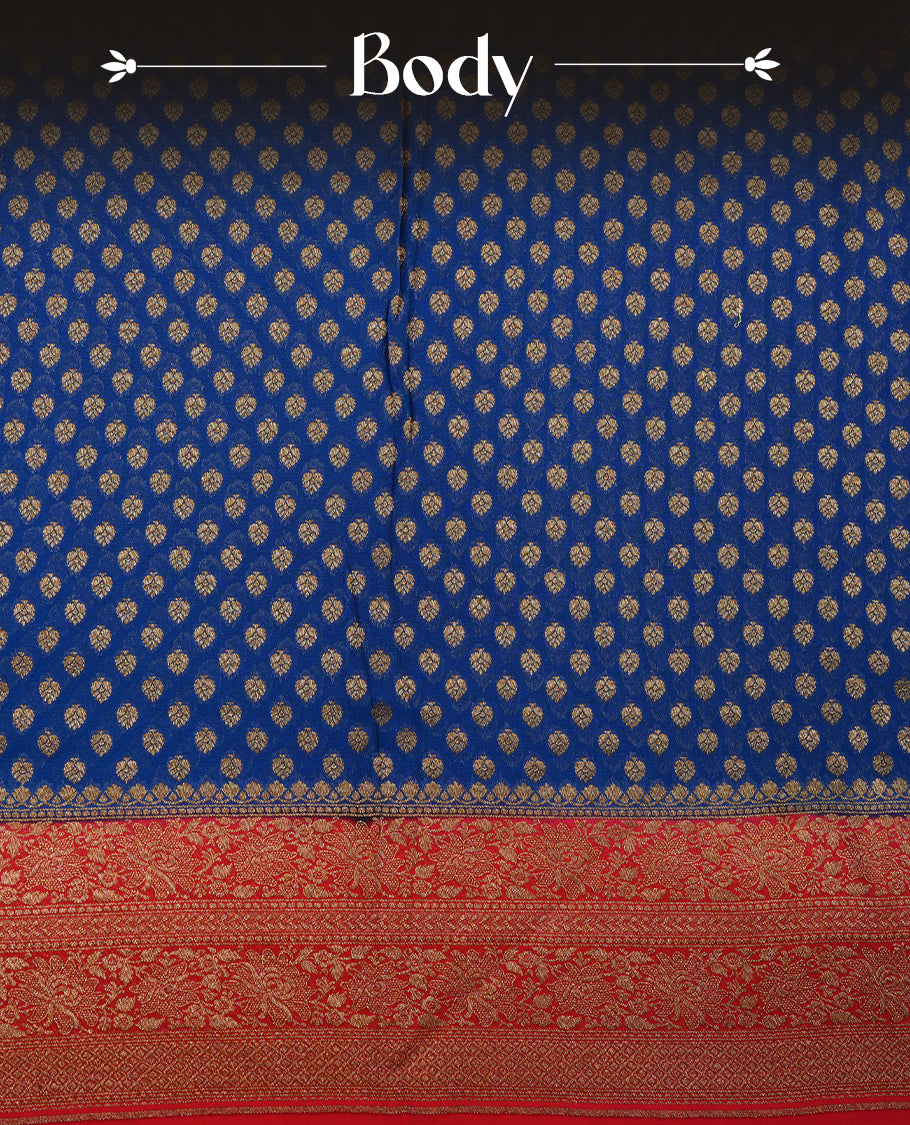 Dark Blue colour pure Banarasi Crepe saree featuring Antique zari Flower Motifs all over the body, complemented by an contrast Red dye colour with gold zari Floral Kodi Worked border and pallu, with matching blouse.