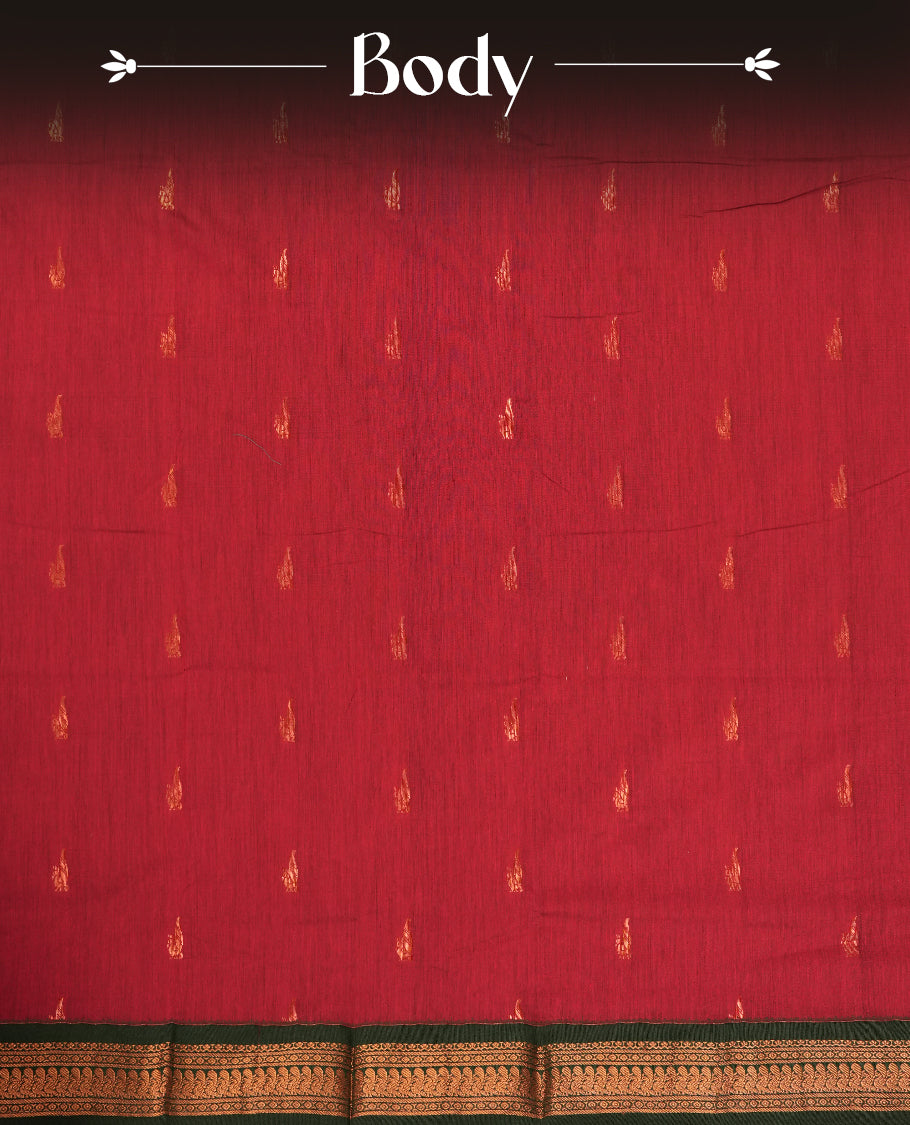 Maroon colour Kalyani cotton saree with subtle zari motifs all over, paired with a contrasting green rich copper zari woven border and pallu & comes with a matching blouse piece.