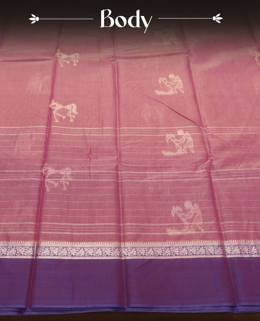 Rose Mauve and Royal Purple Colour silk cotton saree with Warli dancer pallu, subtle pinstripes and pastoral buttas on the body, floral zari border along the purple edge, and a coordinated Rose Mauve blouse with border.
