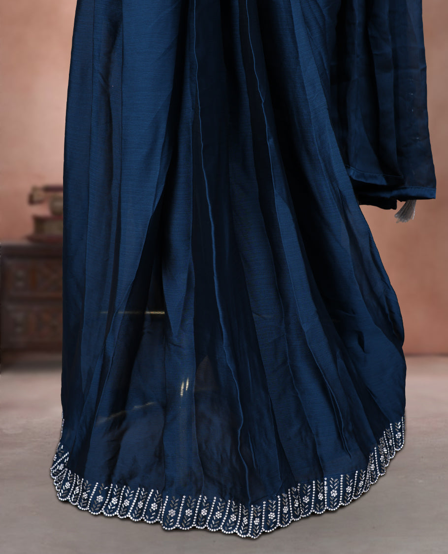 Elegant Teal colour ready to wear saree adorned with rich silver Stone and bead embroidery along the border and pallu, paired with a heavily embellished matching blouse for a grand festive look.