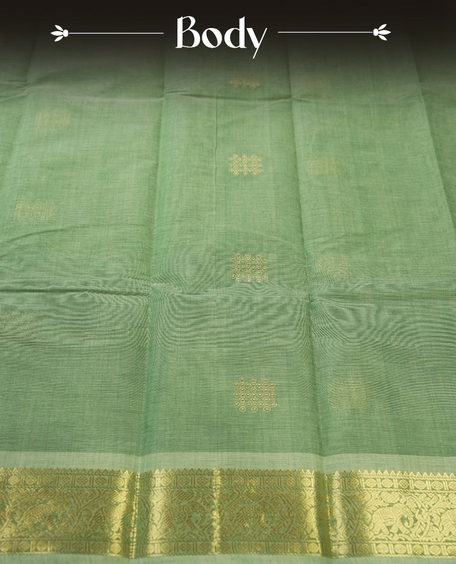 Mint Green colour Pure Kanchi cotton saree featuring delicate golden buttas and a rich zari border with intricate motifs & Paired with a matching blouse, it exudes timeless elegance, perfect for festive and traditional occasions.