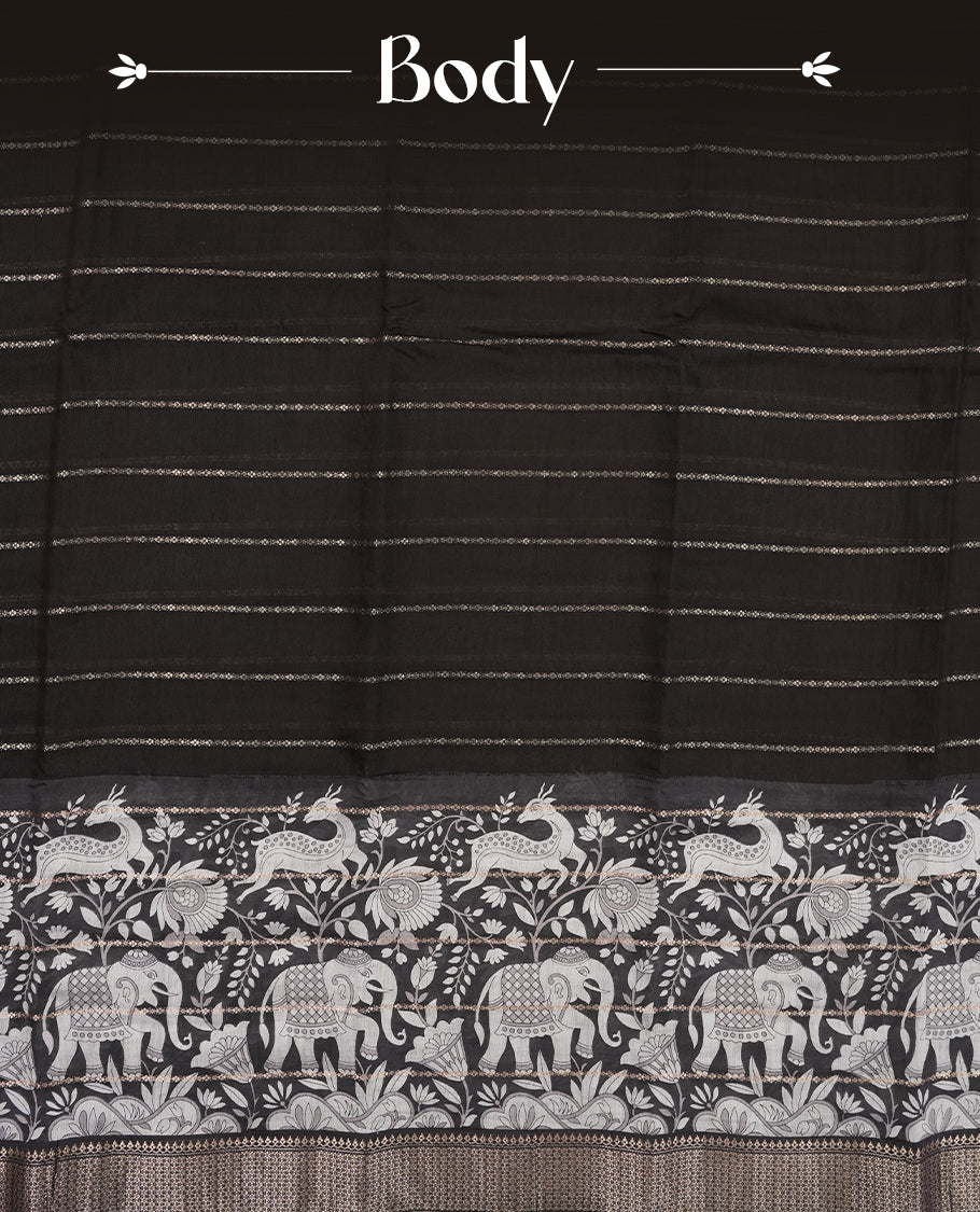 Black colour chanderi silk saree with gold zari strip pattern On body, compilmented by self colour border with antique zari pattern & white animal & forest print pattern and a matching blouse.