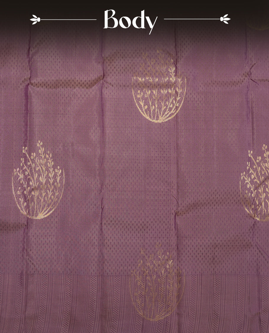 Dusty purple colour Vasundhara silk saree featuring self colour zari motifs across the body, finished with a self‑coloured traditional border with kathir motifs and a coordinating blouse.