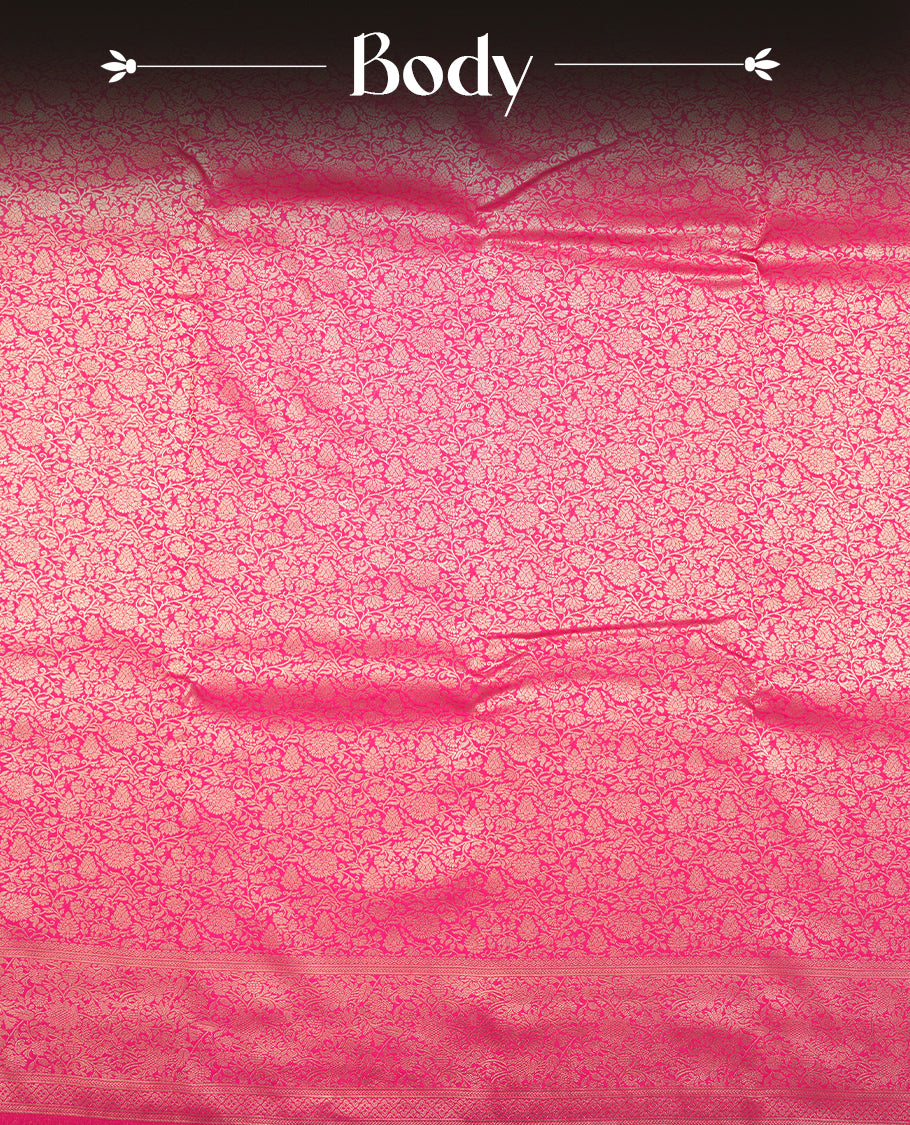 Rani pink colour semi silk brocade saree featuring intricate Gold Floral kodi patterns across the body, complemented by a rich self colour woven border and pallu, paired with a matching blouse.