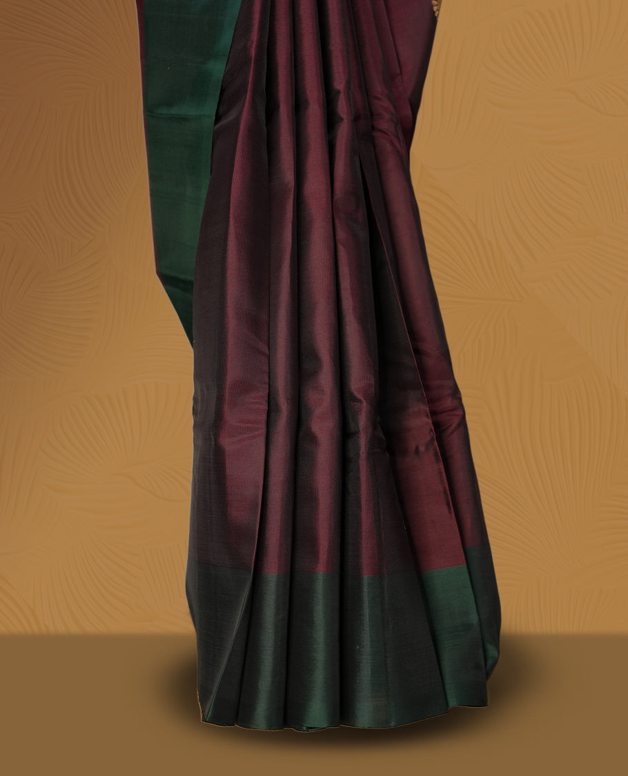 Dark brown colour  soft silk saree adorned with zari motifs, beautifully contrasted with a deep green border and pallu & Paired with a matching blouse.