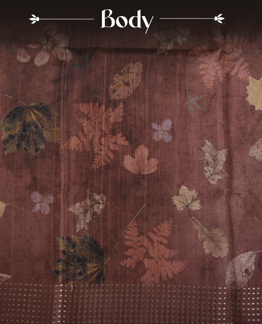 Brown colour tussar saree featuring woven Eco leaves printed on the body, complemented by a self colour gold zari bindi butta border & pallu, paired with a matching blouse.