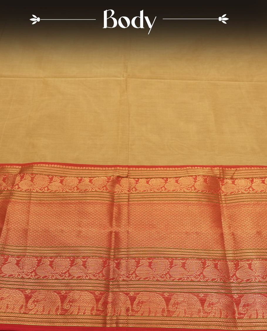 Beige Gold colour Silk Cotton Saree with Contrast Red Zari Border Featuring Elephant and Peacock Motifs, Subtle Allover Body, Richly Patterned Blouse Piece, and Matching Elegant Pallu with Gold Stripes