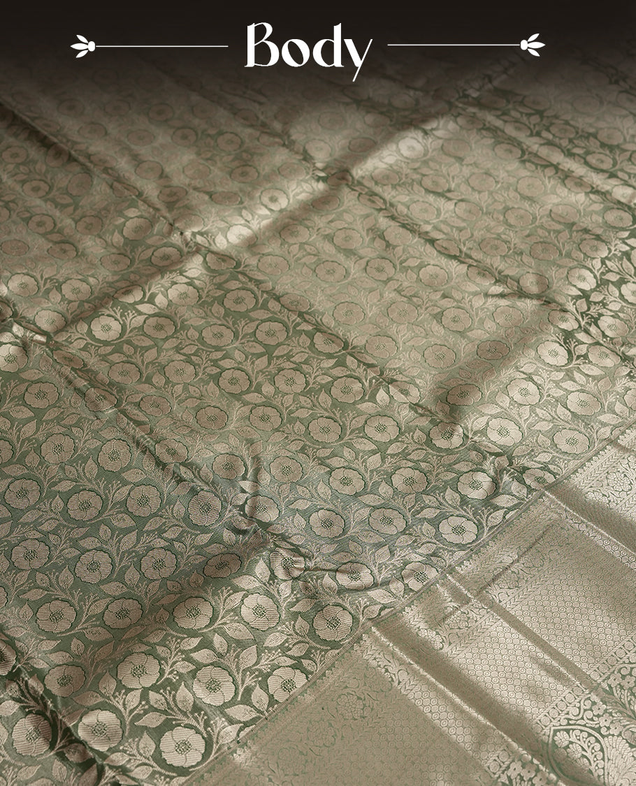 Dull green colour and Antique gold Zari Tissue Brocade Saree features intricate floral Motifs on body and fancy border & pallu with floral patterns, paired with matching blouse