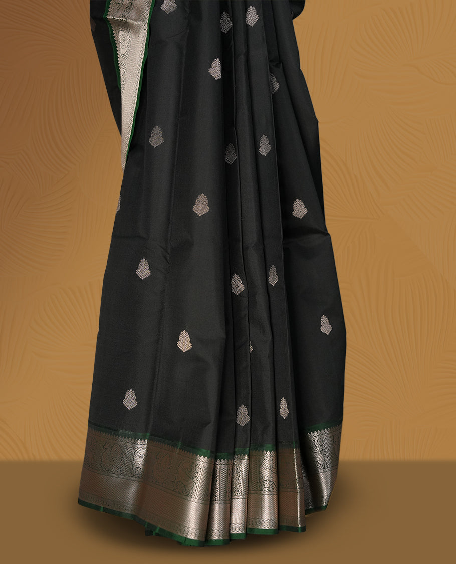 Black colour soft silk saree with green and copper zari border and featuring elegant copper buttas across the body & Paired with a amatching blouse.