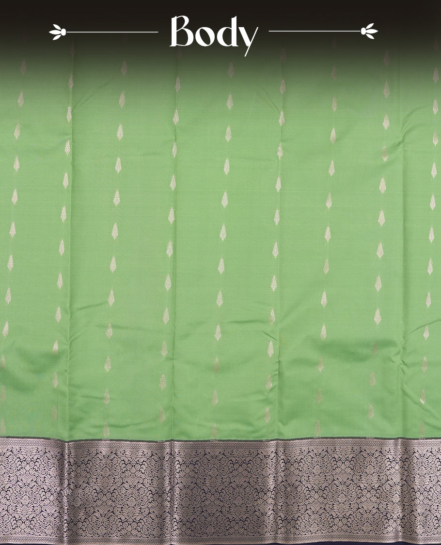 Jade green colour semi soft silk saree featuring a golden textured patterned body, complemented by contrast navy blue with silver zari motifes on pallu & border and a matching blouse piece.