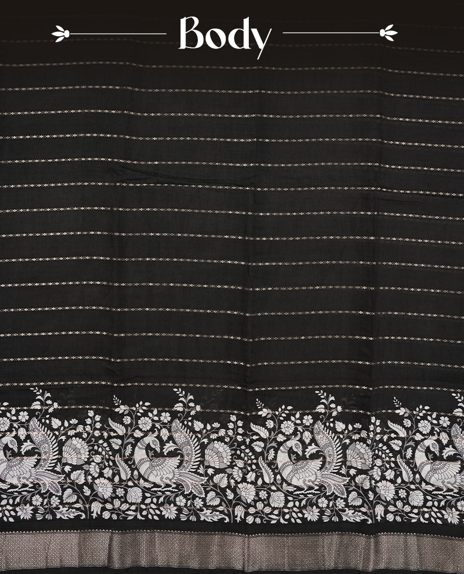 Black colour chanderi silk saree with gold zari strip pattern On body, compilmented by self colour border with antique zari pattern & white peacock & kodi print pattern and a matching blouse.