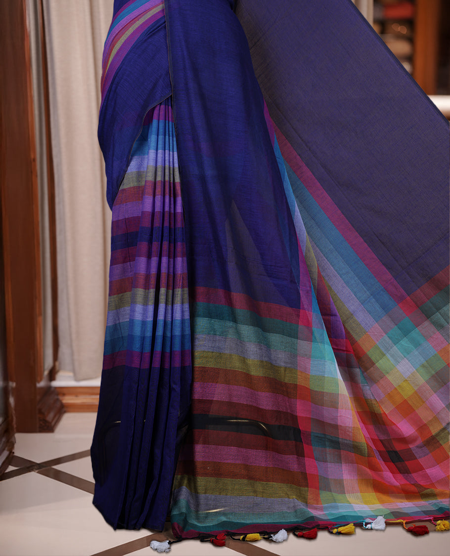 Navy blue colour soft cotton saree with rainbow colored horizontal lines on the body, a vibrant multicolor pallu, and a subtle border & Elegant and lightweight, this saree comes without a blouse piece for a customizable style.