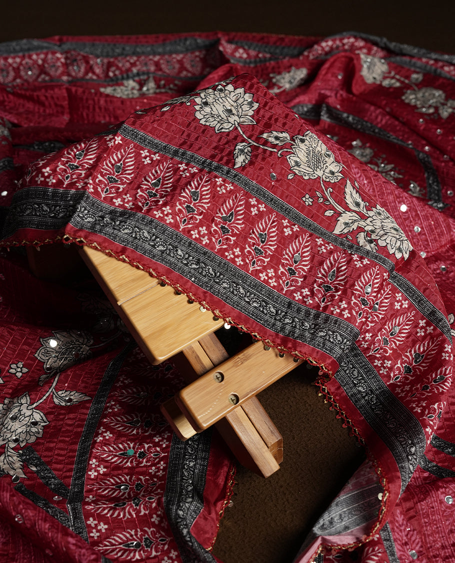 Dark Red colour churidhar material featuring Mirror and thread embroidery, foral print pattern on the self colour front panel, floral digital printed dupatta with elegant border, and matching plain bottom