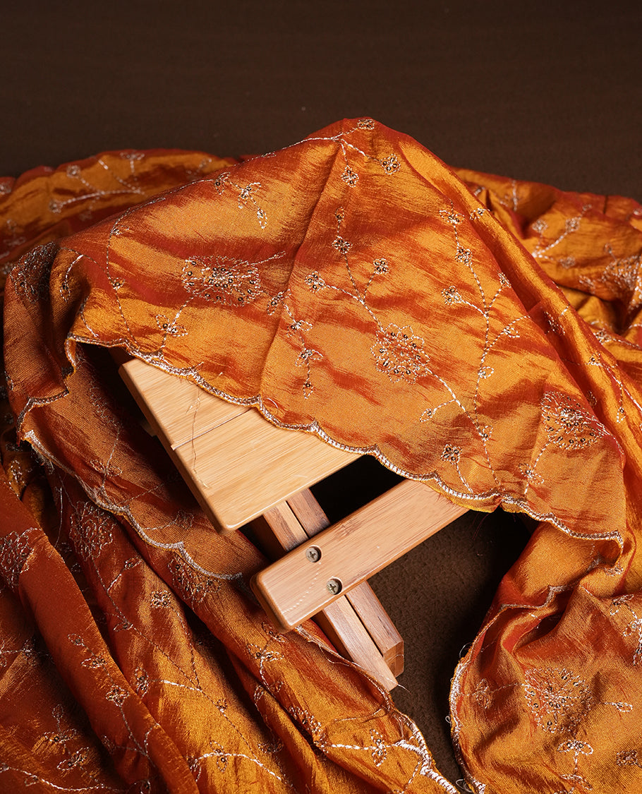 Golden Cream colour churidhar material featuring thread embroidery on the front panel, contrast orange colour dupatta with elegant border, and matching plain bottom