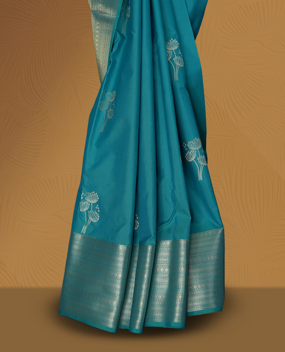 Sky blue colour soft silk saree with silver zari border and matching blouse, featuring delicate silver floral motifs on the body & Paired with a matching blouse.