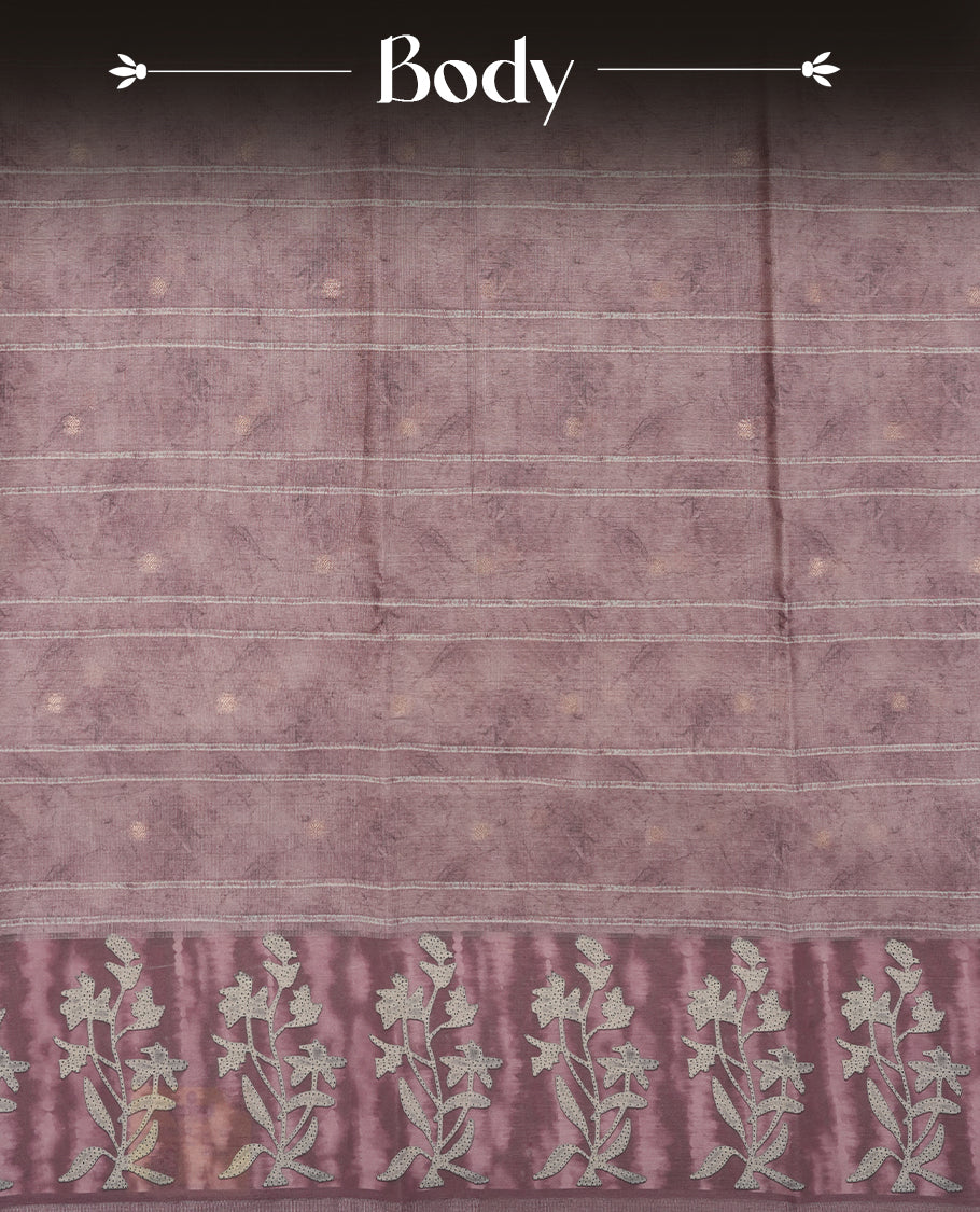 Light Rose copper colour semi tussar saree adorned with Cream strip printed pattern across the body and Floral pattern contrast rose copper colour on border, paired with a matching blouse.