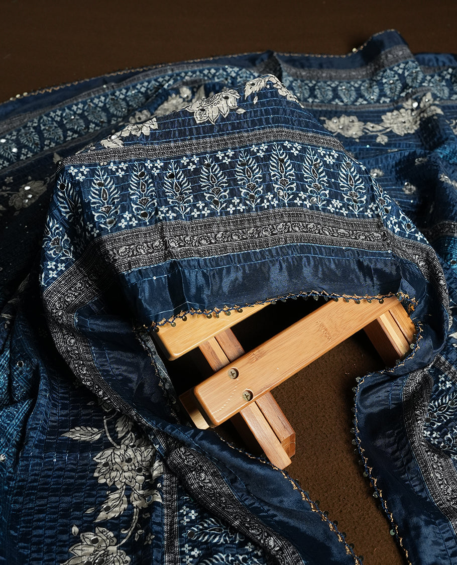 Dark Blue colour churidhar material featuring Mirror and thread embroidery, foral print pattern on the self colour front panel, floral digital printed dupatta with elegant border, and matching plain bottom