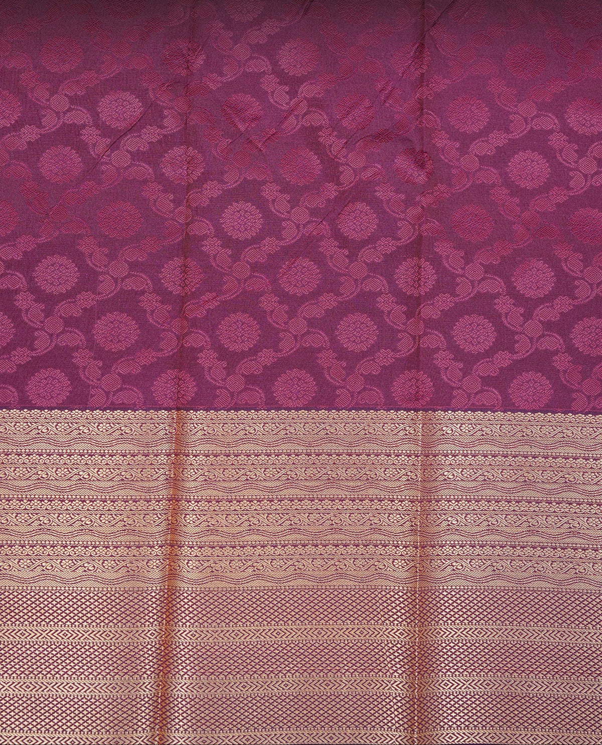 Maroon & gold colour Semi silk saree Featuring self colour zari motifs on body, complemented by contrast burgundy colour with gold zari border, paired with matching blouse piece.