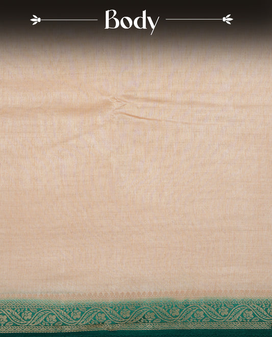 Cream colour Semi Tussar silk saree featuring an elegant plain body, accentuated by a contrast Green border adorned with intricate gold floral kodi zari work, paired with a matching blouse piece.