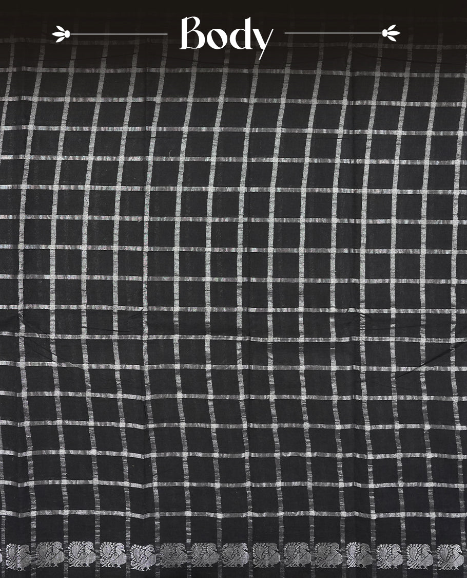 Black colour Chettinad cotton saree featuring silver checked patterns on the body, accentuated with elegant silver peacock motifs along the border & Comes with a matching blouse piece.