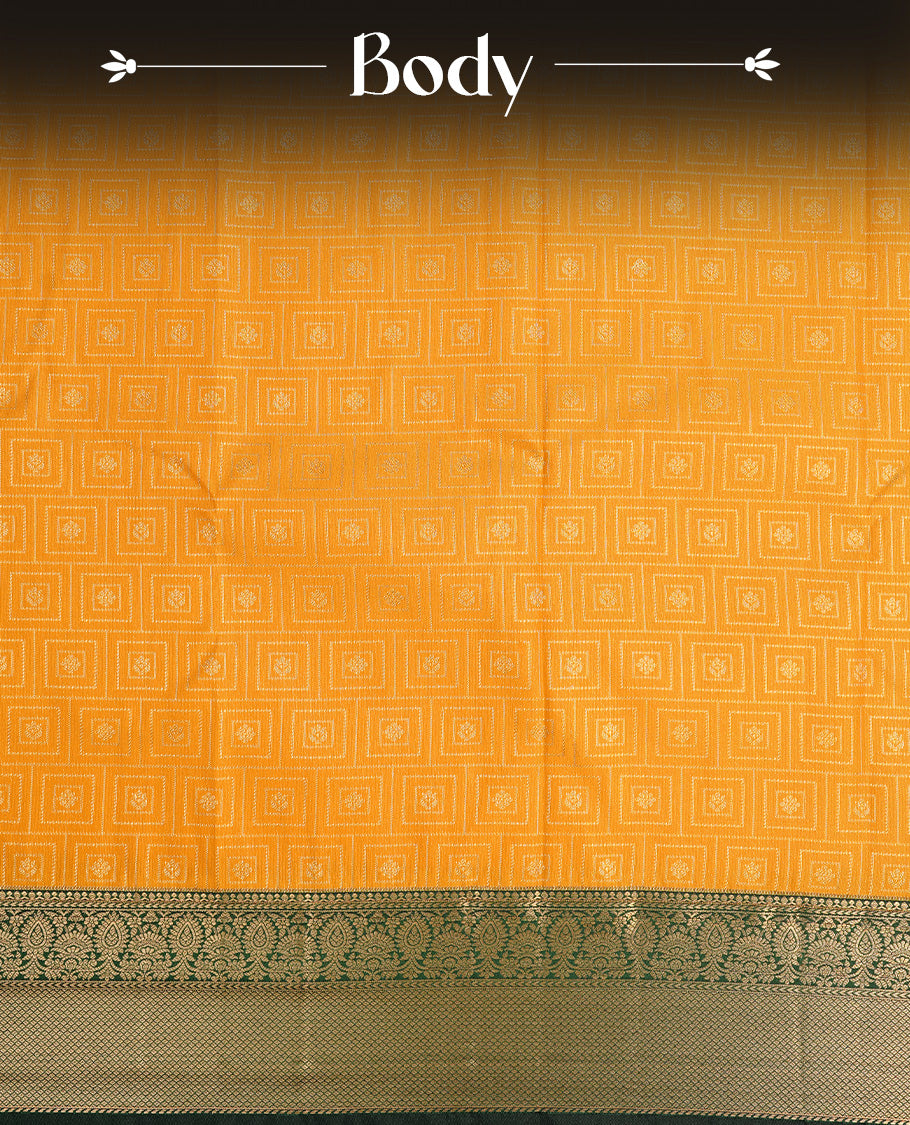 Mustard colour semi wedding saree featuring gold zari motif on check pattern on body, complemented by contrast green with traditional border, paired with matching blouse piece.