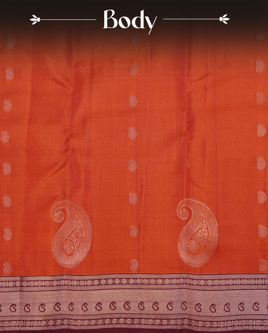 Dark Orange  Colour Traditional Kancheepuram Slik Saree Featuring Gold Zari Mango Motifs on the Body, Complemented by a Contrast Maroon Colour Gold Zari Traditional Border and Pallu, Paired with a Matching Blouse .