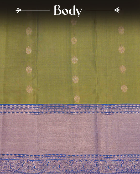 Olive Green Colour Traditional Kancheepuram Slik Saree Featuring Gold Zari Motifs on the Body, Complemented by a Contrast Blue Colour Copper Zari Traditional Border and Pallu, Paired with a Matching Blouse .