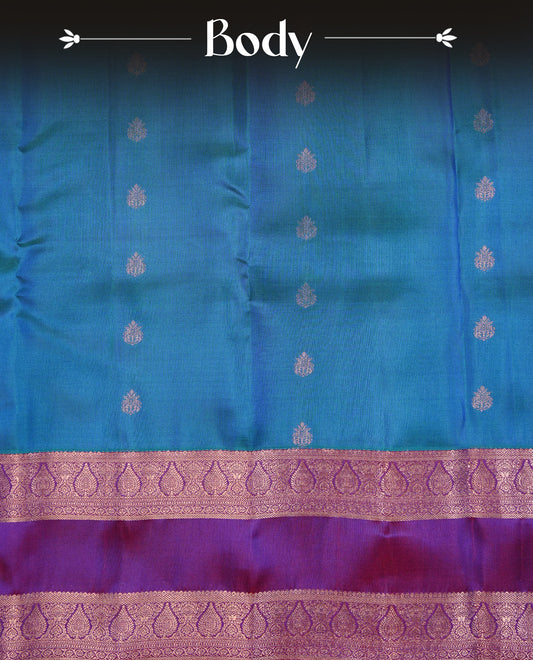 Green & Blue Dual Colour Traditional Kancheepuram Slik Saree Featuring Gold Zari Motifs on the Body, Complemented by a Contrast Purple Colour  Gold Zari Traditional Border and Pallu, Paired with a Matching Blouse .