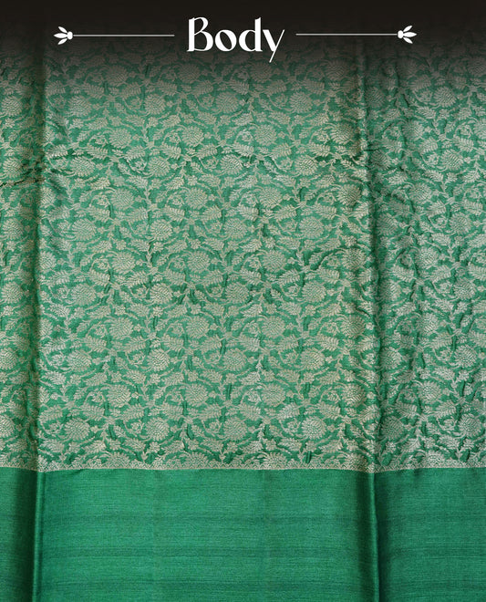 Green  colour pure tussar silk saree featuring light gold zari floral kodi work on the body, a plain border, grand pallu, Paired With  a matching blouse piece.