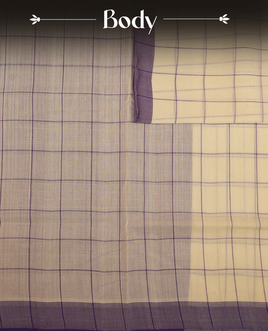 Off-white Mangalagiri cotton saree with delicate lavender checks, a contrast purple border & striped pallu. Paired with a matching blouse piece