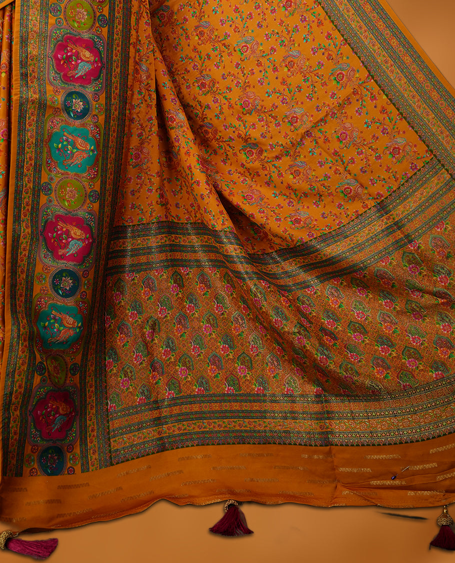 Orange colour Pashmina silk saree densely woven with intricate multicolour floral kodi pattern across the body, framed by an opulent arabesque border and grand storytelling pallu, paired with a matching woven border blouse piece