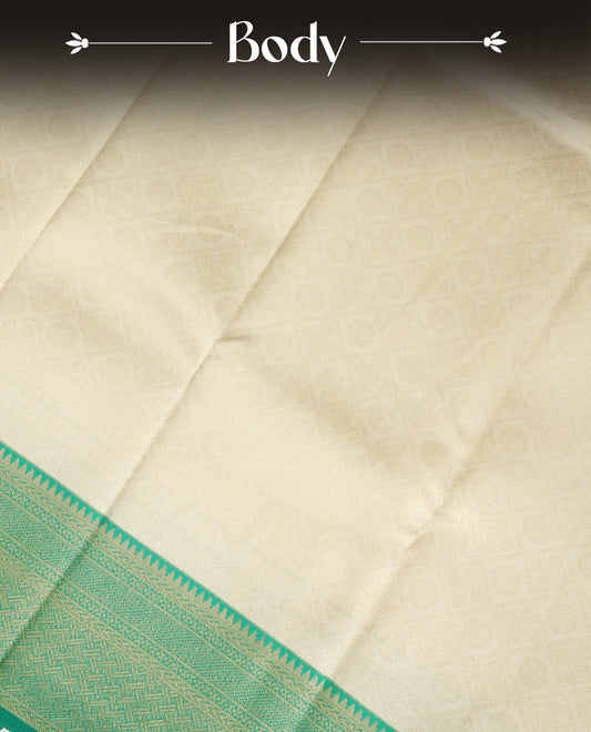 Cream Colour Semi Soft Silk Saree Featuring Gold zari Box With motifs Pattern On Body, Highlighted  by contrast Green border with Gold zari, paired with matching blouse piece.