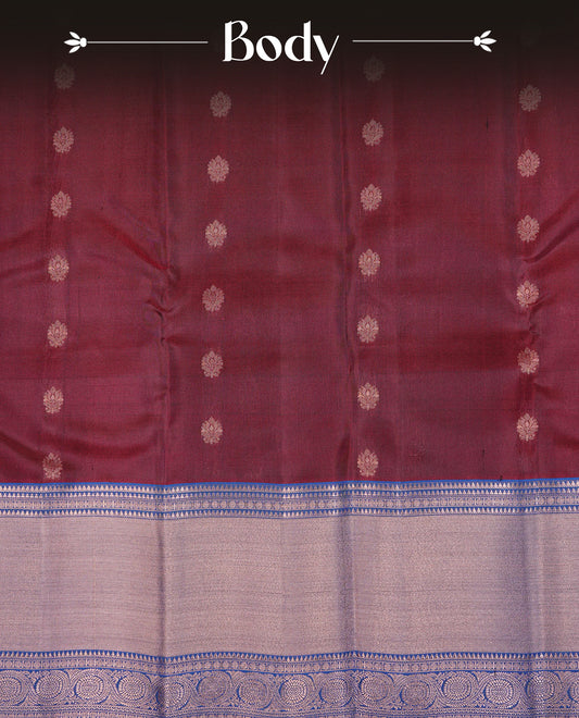 Maroon Colour Traditional Kancheepuram Silk Saree Featuring Gold Zari Floral Motifs on the Body, Complemented by a Contrast Blue Colour  Copper Zari Traditional Border and Pallu, Paired with a Matching Blouse .