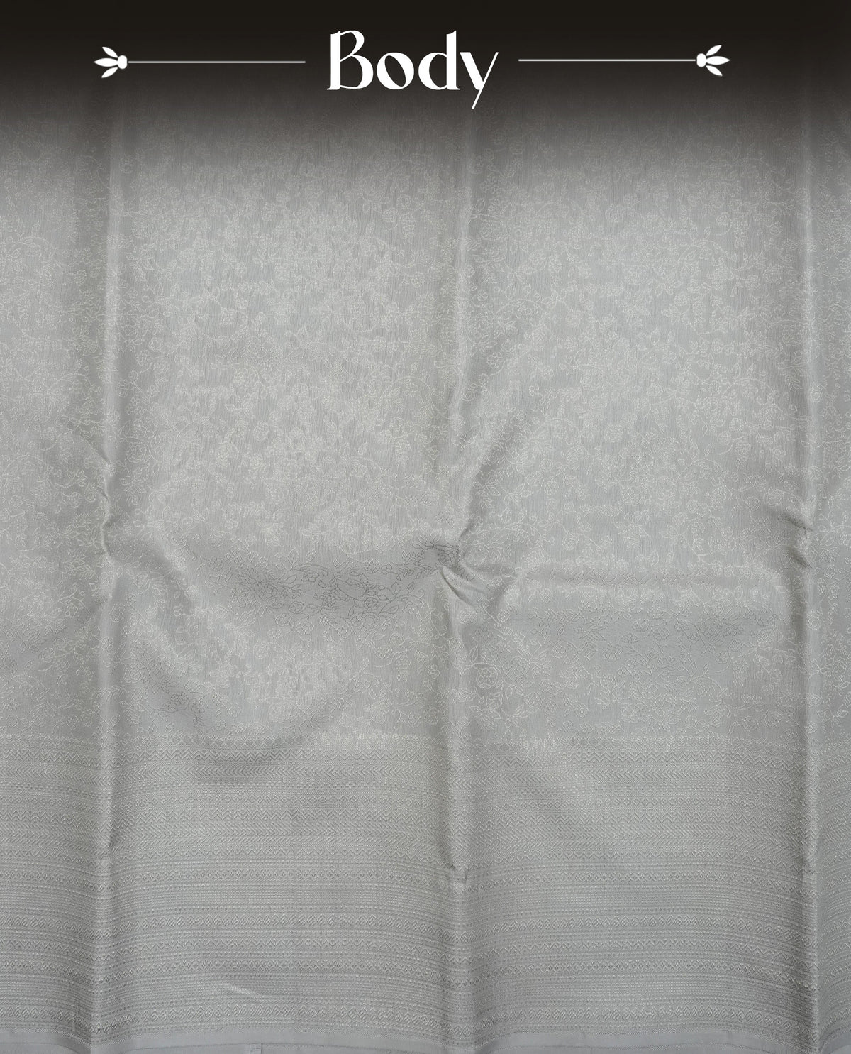 Grey colour pure wedding silk saree featuring Silver zari Floral kodi pattern on body, complemented by self colour with traditional border, comes with matching blouse piece.