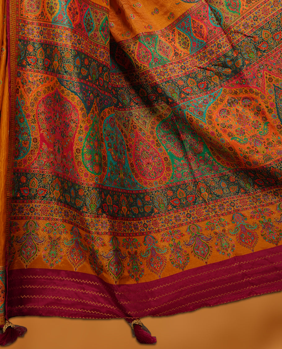 Mustard colour Pashmina silk saree densely woven with intricate multicolour floral motifs across the body, framed by an opulent arabesque border and grand storytelling pallu, paired with a matching woven border blouse piece