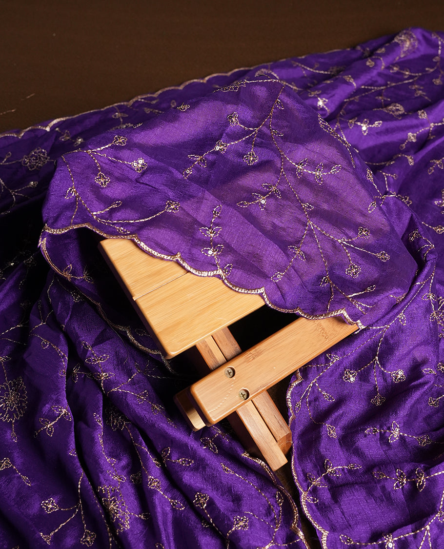 White colour churidhar material featuring thread embroidery on the front panel, contrast Violet colour dupatta with elegant border, and matching plain bottom