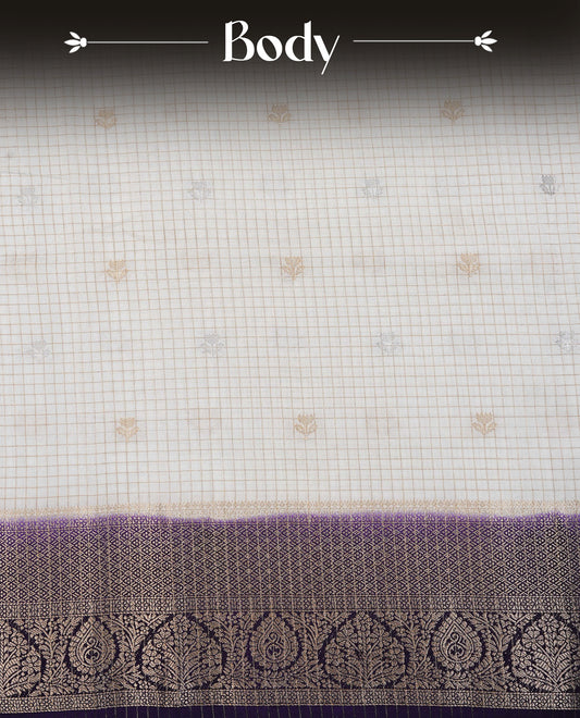 Semi Banaras Tussar Saree Featuring Gold Zari Check With Floral Pattern On Body , Burgundy Colour  With Gold Zari Border , Paired With  A Matching Blouse Piece.