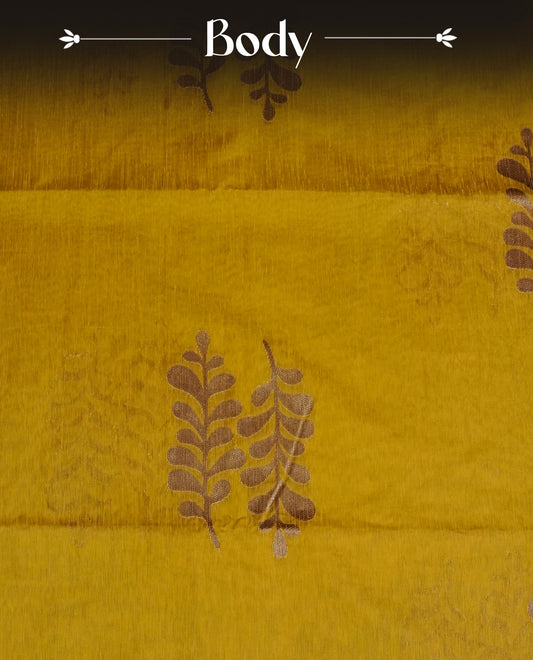 Mustard colour semi linen saree with elegant gold zari Leaf motifs across the body, complemented by a contrast colour with grand gold zari pallu and a borderless design, paired with a matching blouse piece.