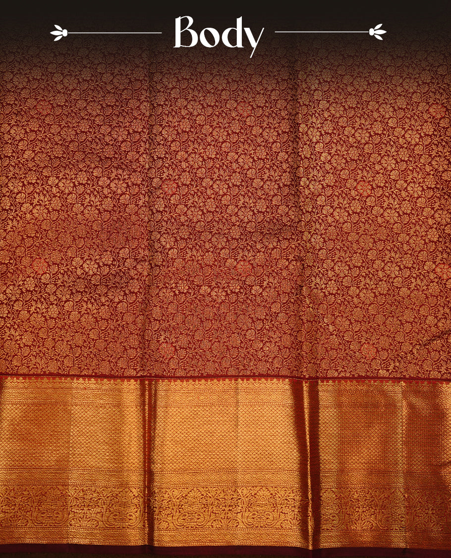Chocolate colour kancheepuram silk saree featuring gold zari floral kodi pattern on body, complemented by self colour with traditional border, paired with matching blouse piece.